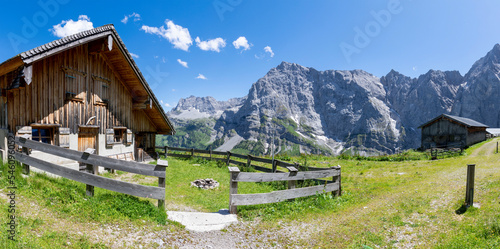 The north walls of Karwendel mountains with the typical chalet - Hahnkampl and Lamsen spitze peaks.