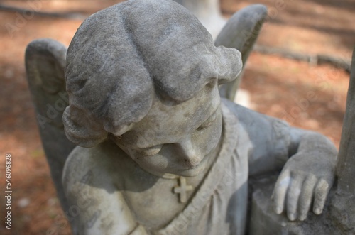 Close up of small  angel on gravestone in cemetery