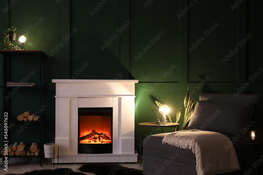 Fototapeta premium Interior of dark living room with fireplace, glowing lamps and shelving unit