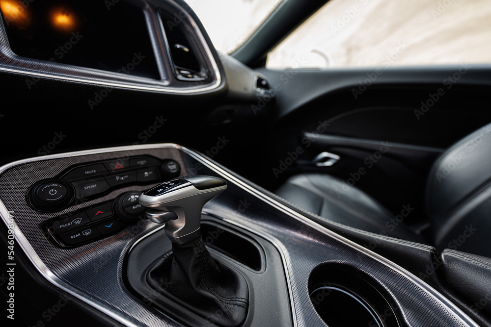 Interior of the muscle car. Close up of the automatic gearbox lever,  Automatic transmission gearshift stick.