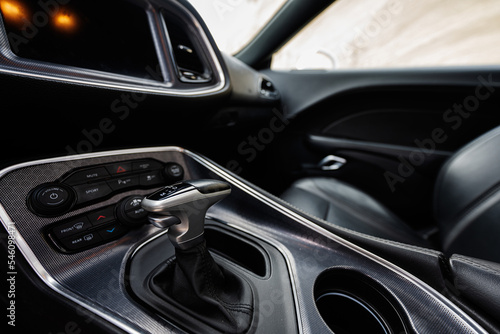 Interior of the muscle car. Close up of the automatic gearbox lever, Automatic transmission gearshift stick.