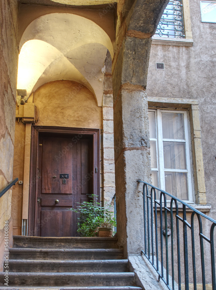Traboule and old door in Lyon old district of Saint Jean, picturesque historic passageways between streets	