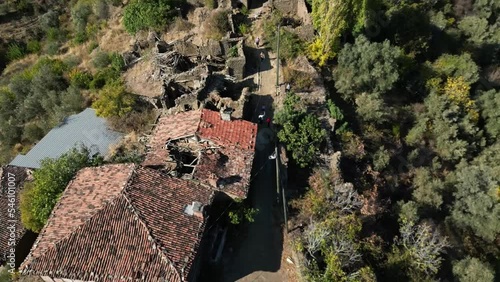 ootage starts with roof view of the houses and then looks up slowly and goes forward at abandoned lubbey village aka camyayla village in izmir ,turkey