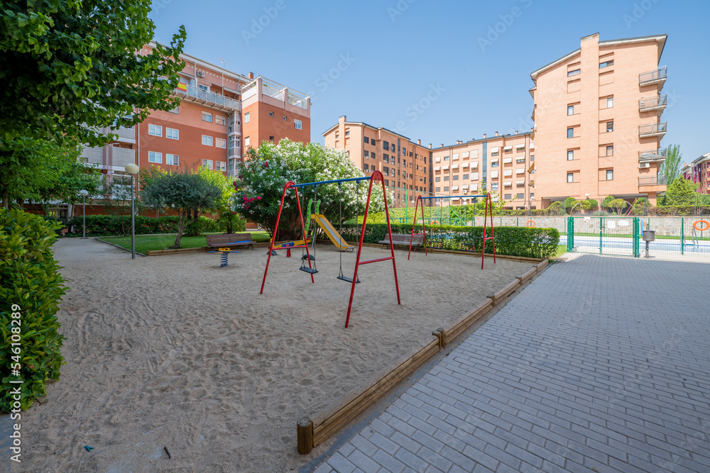 Gardens and playground of an urbanization with common areas Gardens and playground of an urbanization with common areas