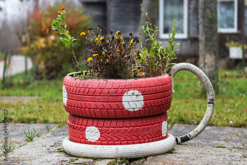 An artistic cup with flowers, made from old tires. photo