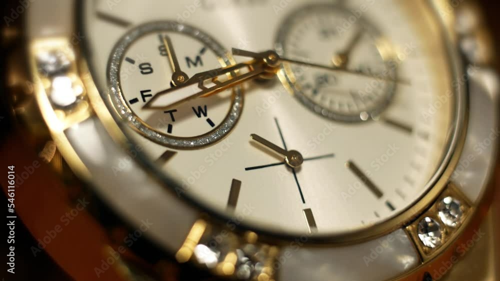 Clock hands in motion on the glamorous dial clock face of a gilded gold plated mechanical quartz chronometer watch close-up macro. Running of time and life Clock hands in motion on the glamorous dial clock face of a gilded gold plated mechanical quartz chronometer watch close-up macro. Running of time and life
