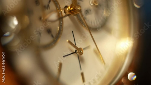 Clock hands in motion on the dial clock face of a gilded gold plated mechanical quartz glamorous chronometer watch close-up macro. Running of time and life 