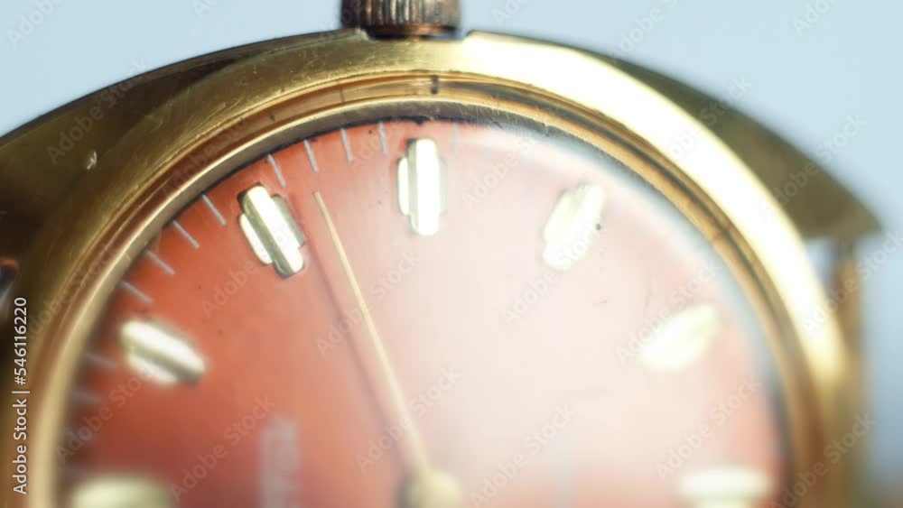 Hands of the clock in motion on the dial clock face of an gilded gold plated old mechanical chronometer watch close-up. Running of life and time flow Hands of the clock in motion on the dial clock face of an gilded gold plated old mechanical chronometer watch close-up. Running of life and time flow