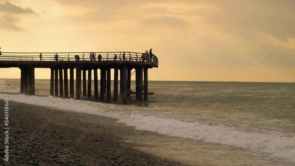 Slow motion video. View of the pier from the side on the seashore. Slow motion video. View of the pier from the side on the seashore.