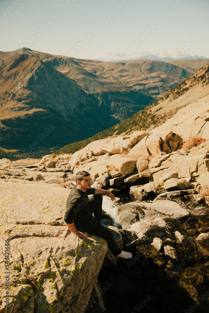 Naklejka premium Boy looking at an impressive mountain landscape from the top