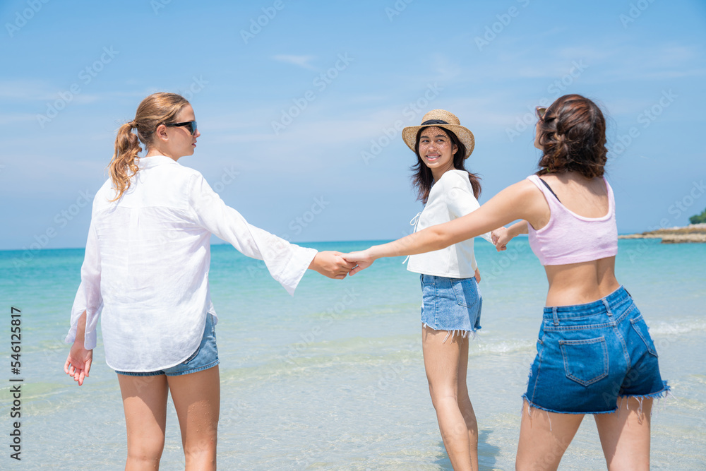 Happy teenagers at beach party together on the beach having fun in a sunny day, Beach summer holiday sea people concept