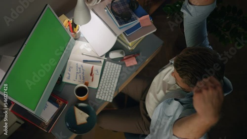 Relaxed guy stretching home workplace top view. Ginger man making pause working