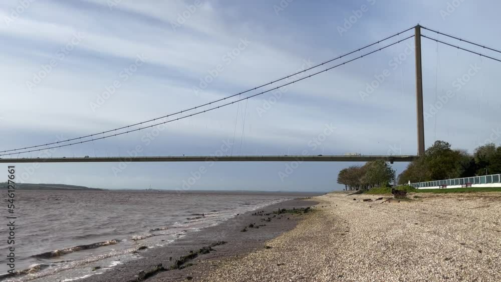 Humber Bridge in Hessle, by Hull, England, UK. Tide coming into the estuary Humber Bridge in Hessle, by Hull, England, UK. Tide coming into the estuary