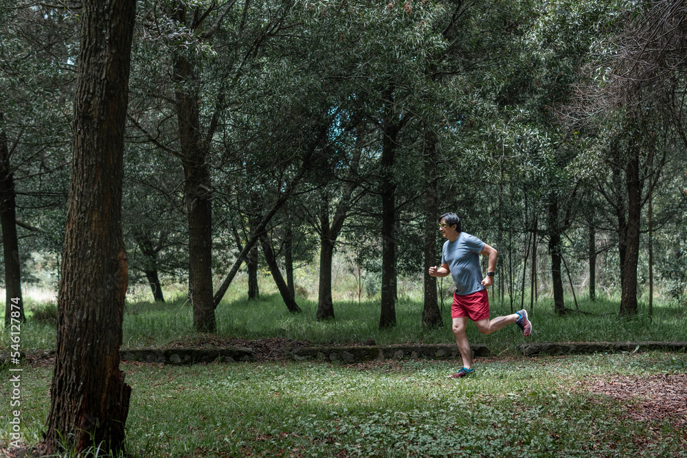 Adult Latino man running through the woodsmountain, Adult Latino man running through the woodsmountain,