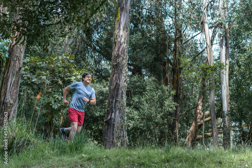 Latino man running in a morning in the middle of a forest © FABIAN PONCE GARCIA