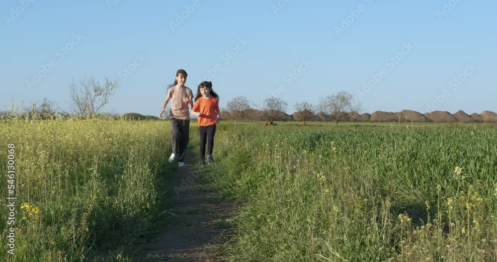 Have fun with your sister in nature. Happy little girls running together in nature on tro. Have fun with your sister in nature. Happy little girls running together in nature on tro.