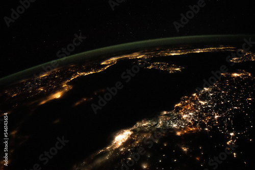 Aerial space view, cities light up the night. Nighttime view from space of the Mediterranean Sea from north Africa to southern Europe. Elements of this image furnished by NASA.