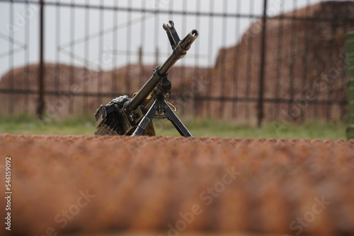 Almaty, Kazakhstan - 04.14.2022 : A Kalashnikov assault rifle is mounted against the background of a number of ammunition.