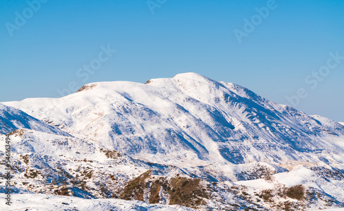 Snow covered hmountain peak and blue sky