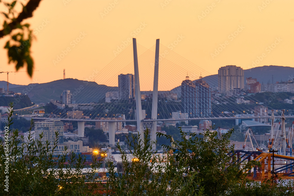 Vladivostok, Russia - Sep 18, 2022: View of the Golden Bridge cable-stayed bridge over the Golden Horn Bay in the morning at dawn.