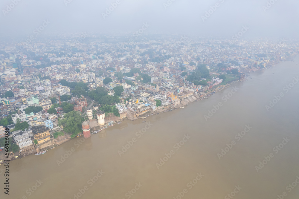 Fototapeta premium Aerial view of Varanasi city with Ganges river, ghats, the houses in Varanasi, Banaras, Uttar Pradesh, India