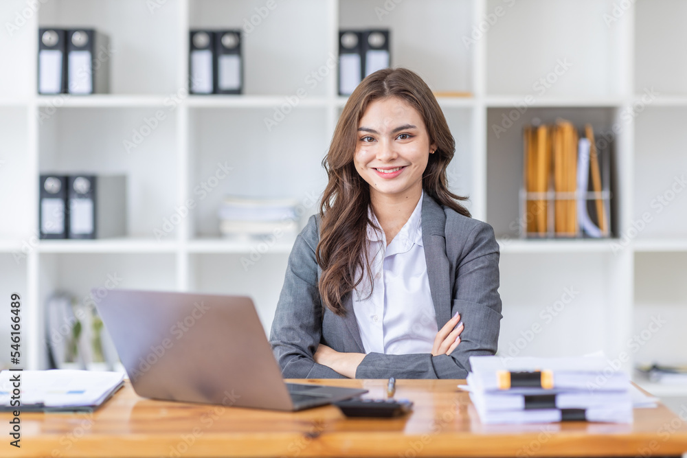 Young business Asian woman Accounting using calculating income-expenditure and analyzing real estate investment data report Financial and tax systems concept. Young business Asian woman Accounting using calculating income-expenditure and analyzing real estate investment data report Financial and tax systems concept.