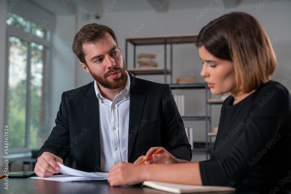 Inspired businessman and businesswoman in formal suit discuss signing contract Inspired businessman and businesswoman in formal suit discuss signing contract