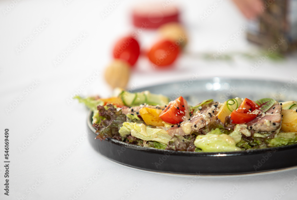 Vegetable salad with meat on a plate close-up. Vegetable salad with meat on a plate close-up.