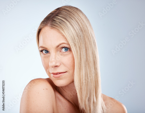 Portrait  hair and natural with a model woman in studio on a gray background for wellness or treatment. Face  haircare and face with an attractive young female posing to promote a keratin product
