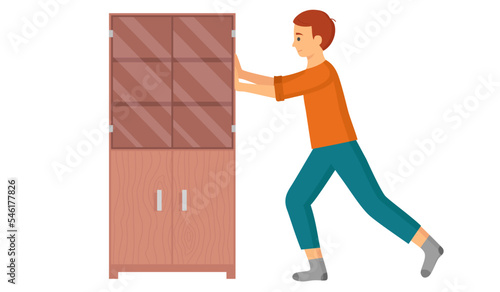 Man moving closet, makes repairs to house or rearranges furniture to another place. Young person assembling wooden wardrobe engaged in manual house work. Concept of change of scenery, new family home