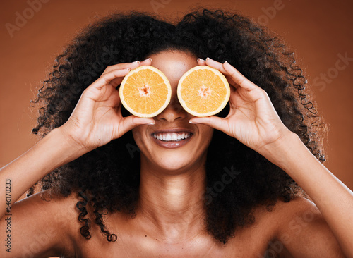 Beauty, skincare and black woman with orange product for cosmetics healthcare, organic and vitamin c treatment. Fruit for skin health, healthy diet and nutrition lifestyle model on studio background photo