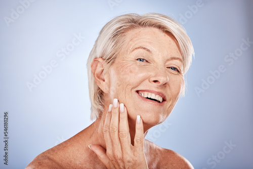 Face  beauty and antiaging with a senior woman touching her skin in studio on a gray background for wellness. Portrait  cosmetics and treatment with a mature female posing to promote natural care