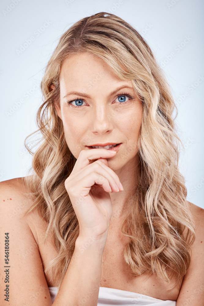 Face portrait, beauty skincare and woman in studio on a blue background. Luxury makeup, natural cosmetics and aesthetics of female model from Canada thinking about facial health and skin wellness. Face portrait, beauty skincare and woman in studio on a blue background. Luxury makeup, natural cosmetics and aesthetics of female model from Canada thinking about facial health and skin wellness.