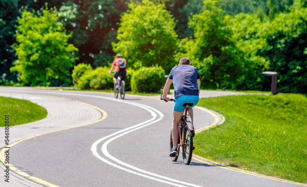 Fototapeta premium Cyclist ride on the bike path in the city Park 