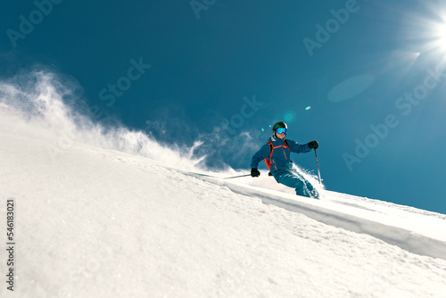 Very fast skier rides over ski slope. Freeride concept