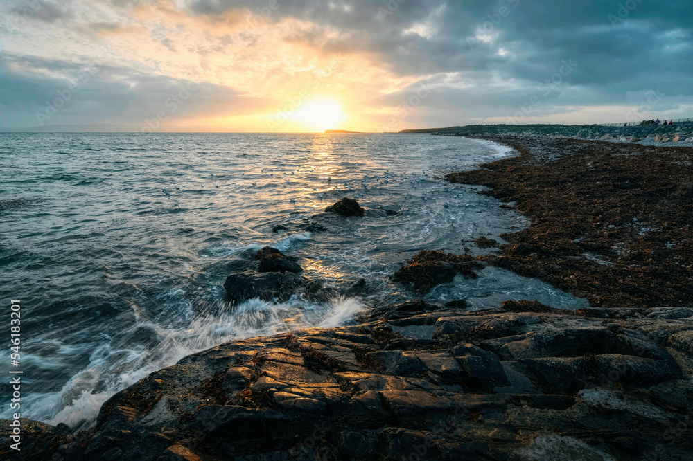 Beautiful seascape sunset scenery of rocky coast at wild atlantic way, Salthill beach, Galway, Ireland 