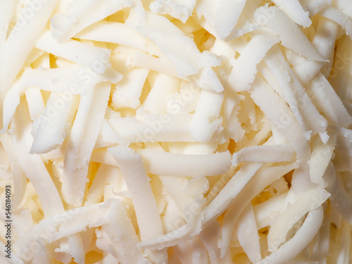 Freshly grated mozzarella cheese close-up. Selective focus.