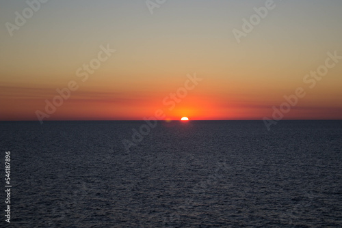 evocative image of sunset over the calm sea on a beautiful day © massimo