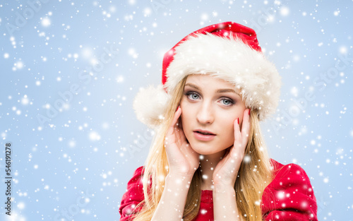 Portrait of young and pretty girl in Santa hat. New year and Christmas concept.