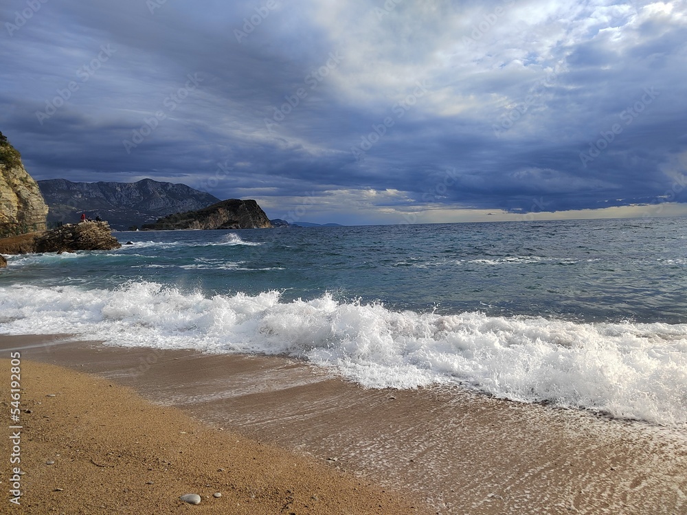 Stormy sea. Morning after the storm on the beach. beautiful autumn scenery. stones on the sand. big waves on the water. clouds in the sky. wide panoramic view Stormy sea. Morning after the storm on the beach. beautiful autumn scenery. stones on the sand. big waves on the water. clouds in the sky. wide panoramic view