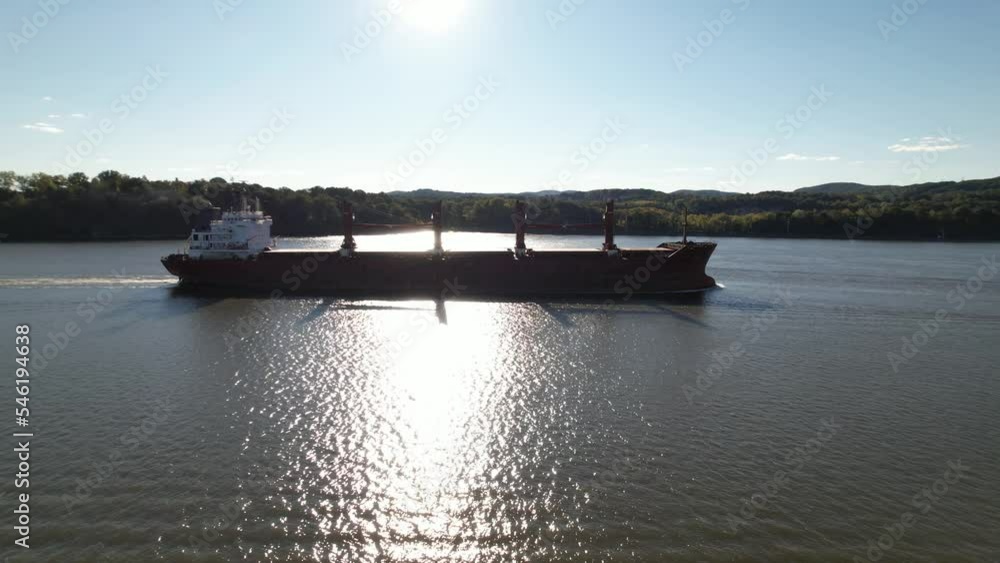 An aerial view over the Hudson River in upstate NY on a beautiful day with sunny skies. The camera truck left and pan right over the water, following a large oil tanker sailing on the river. An aerial view over the Hudson River in upstate NY on a beautiful day with sunny skies. The camera truck left and pan right over the water, following a large oil tanker sailing on the river.
