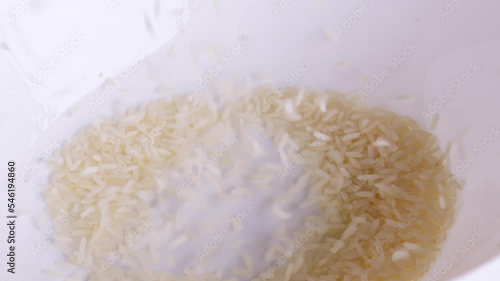 Rice grains that have been cleaned of husks into bowls ready to be ...