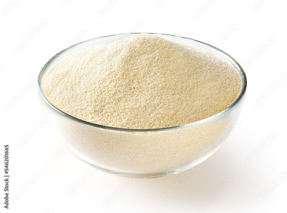 Semolina flour in glass bowl isolated on white background Semolina flour in glass bowl isolated on white background