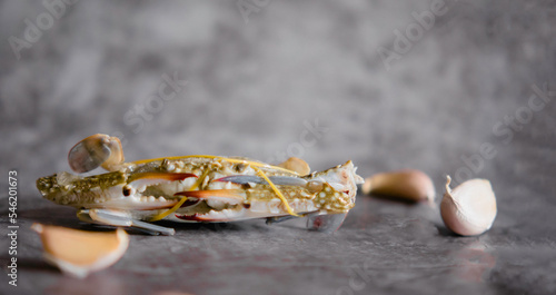 Close-up shot of fresh blue crab isolated on background, sea crab. Seafood. Seafood and spices concept. Garlic.