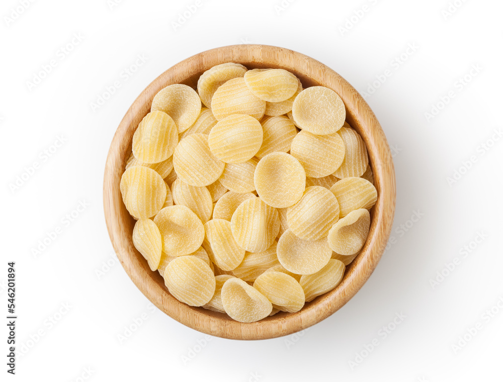 Uncooked orecchiette pasta in wooden bowl isolated on white background with clipping path