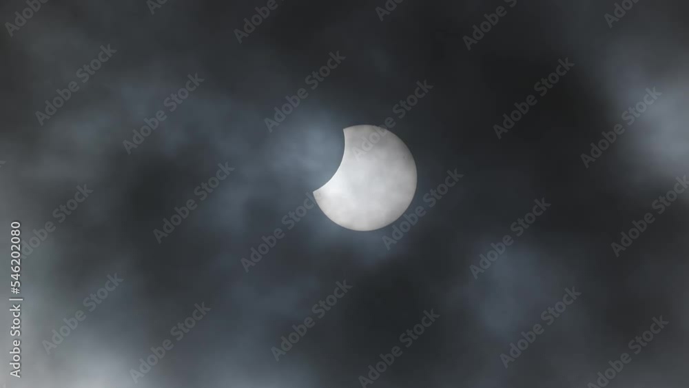 Close up of partial lunar eclipse with dark clouds floating past in the foreground. Close up of partial lunar eclipse with dark clouds floating past in the foreground.