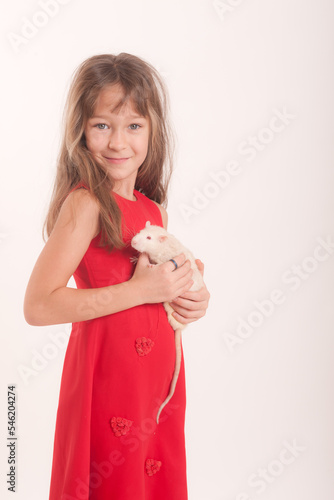 studio portrait of a girl in a dress with a white domestic rat