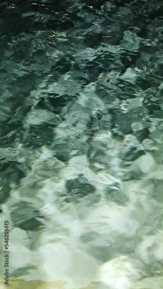 Light and shadows play on the waves with reflection. An interesting background for change and movement. Light waves turn into dark ones. Vertical Light and shadows play on the waves with reflection. An interesting background for change and movement. Light waves turn into dark ones. Vertical