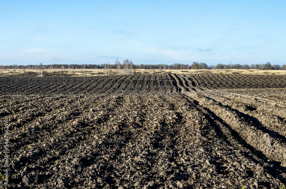 Plowed field in the autumn time with blue sky. Plowed field in the autumn time with blue sky.