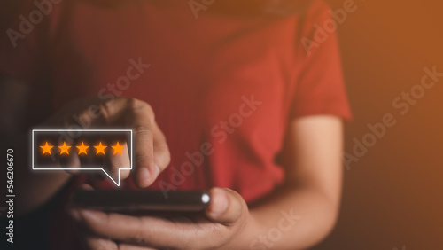 Fotografie Customer touch smart phone on screen to review satisfaction feedback survey concept, User give rating to service experience on online application, Customer can evaluate quality of service leading